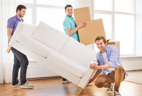 Local movers handling boxes and furniture for a Chelsea flat relocation