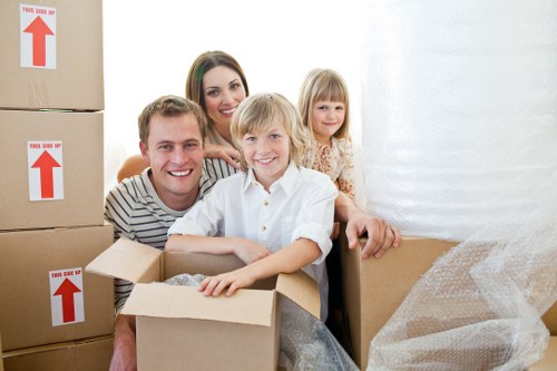 Local removals crew handling furniture in a Chelsea property
